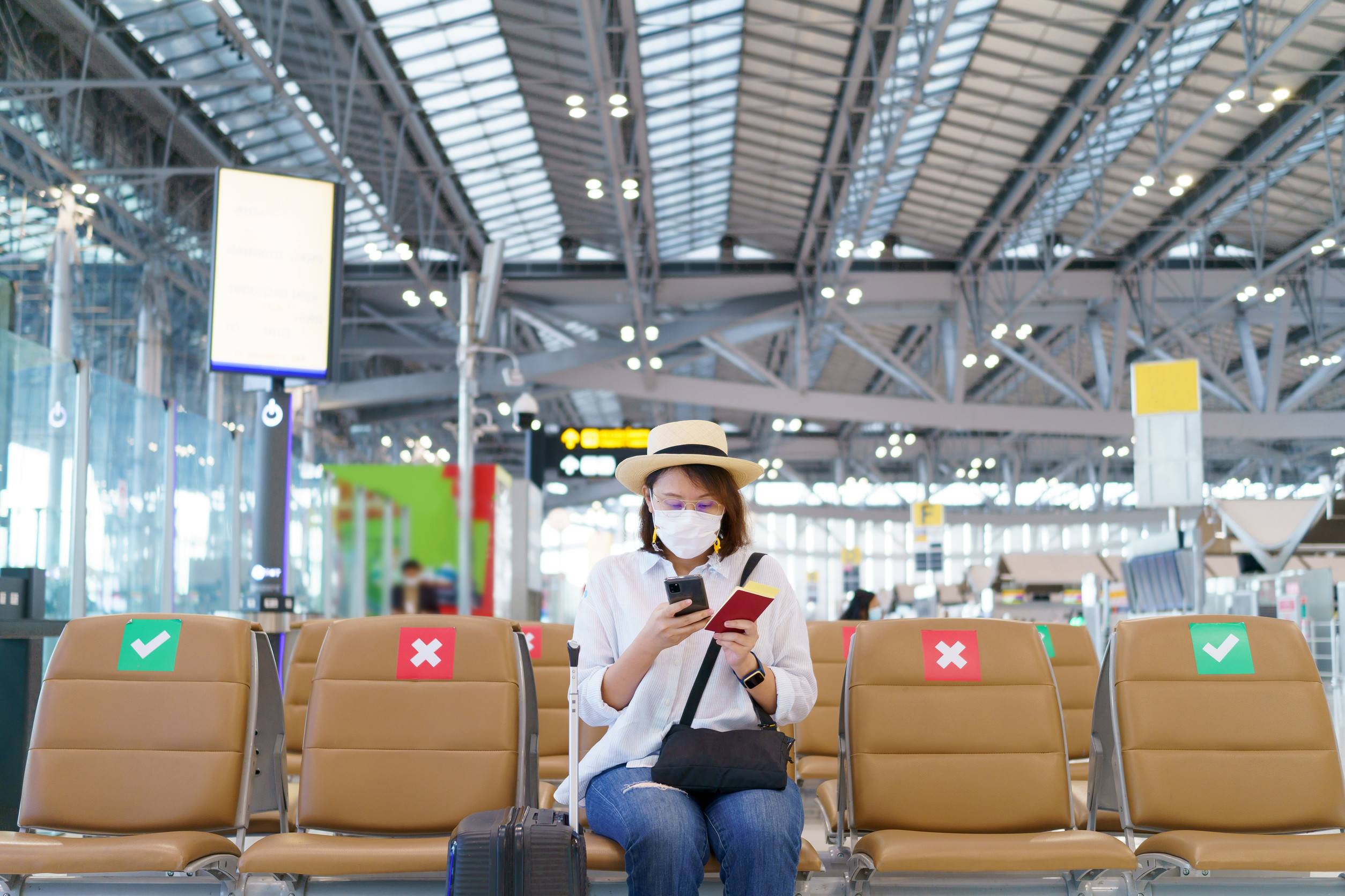 Turista con mascherina in viaggio in aeroporto, distanziamento sociale, assistenza sanitaria Turista con mascherina in viaggio in aeroporto, distanziamento sociale, assistenza sanitaria
